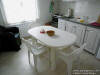 The seperate full furnished kitchen  with dining table of the apartment
