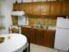 The full furnished kitchen with dining table of one the Apartments