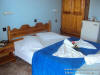 Room with double bed and fridge