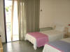 Bedroom with 2 single beds of Karamela Apartment